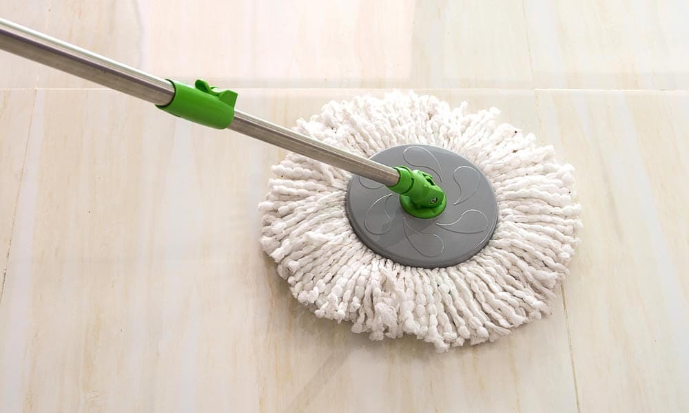 cleaning floor with white fabric